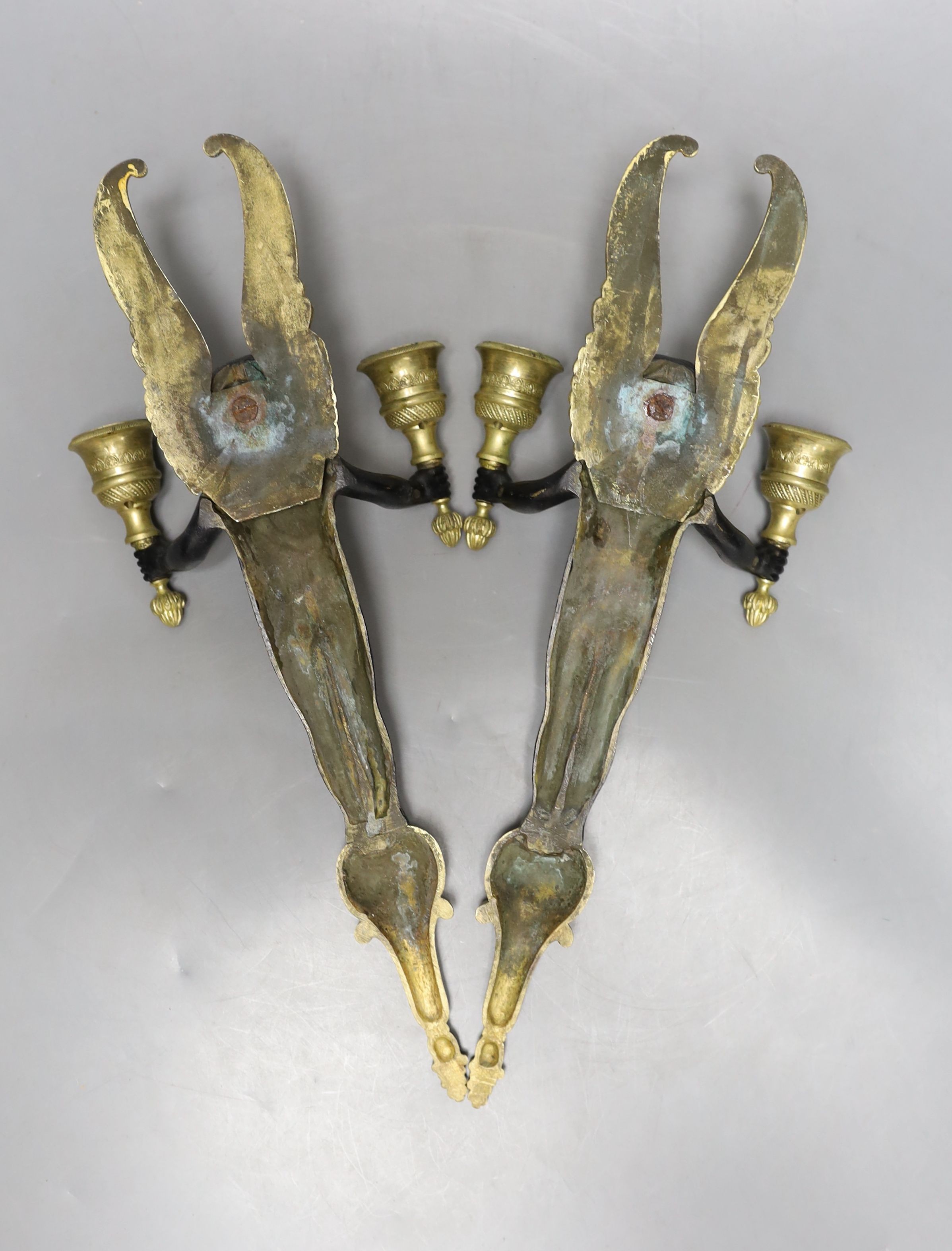 A pair of bronze ‘cherub’ wall sconces 34cm
